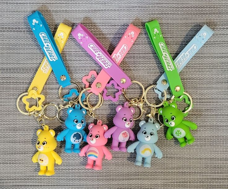 four key chains with different colored bears on them