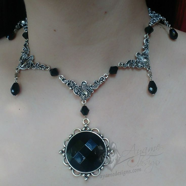 Introducing the Monami choker! This piece features beautifully detailed filigree charms decorated with black crystal bicone and teardrop beads, finished off with a black resin cabochon pendant. This piece has an adjustable length of 36-41cm. Please add a note if you would like it a different length. All metal findings except the charms are stainless steel. All the charms are coated with Everbrite coating which means that it is safe for people with metal allergies, and will not tarnish! Ornate Black Metal Necklace, Black Pendant Necklace With Intricate Design, Gothic Metal Jewelry With Black Beads, Gothic Black Beaded Metal Jewelry, Black Teardrop Metal Necklace, Black Metal Teardrop Necklace, Black Victorian Choker Necklace, Black Teardrop Pendant For Jewelry Making, Ornate Handmade Black Necklace