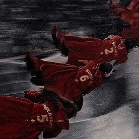 two skateboarders in red jackets are doing tricks