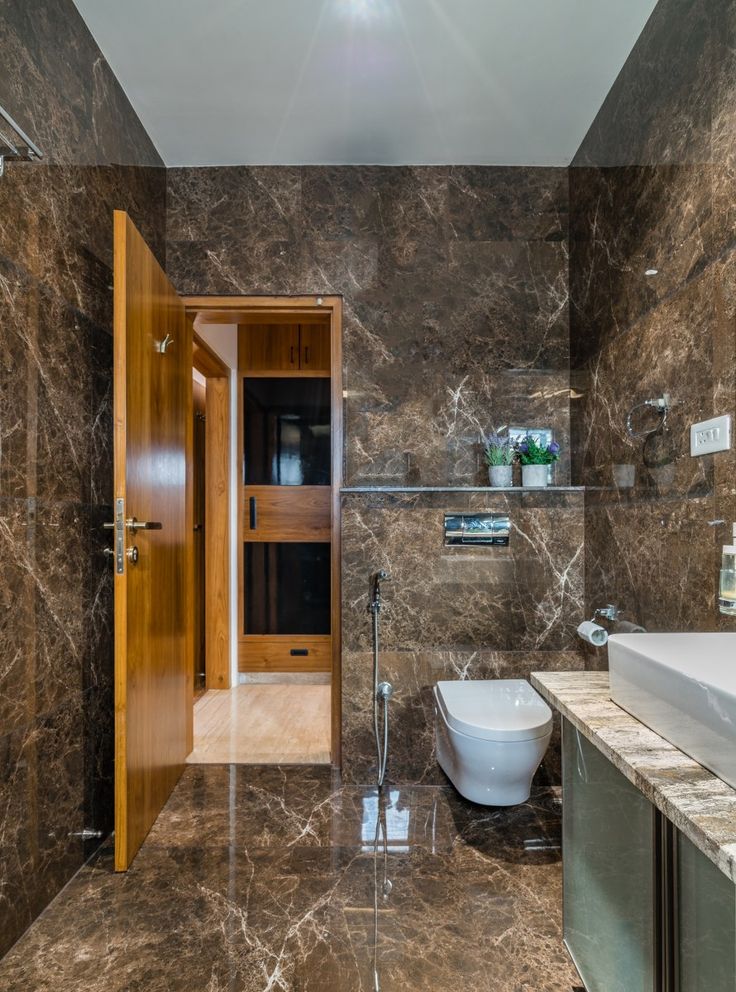 a bathroom with marble walls and flooring