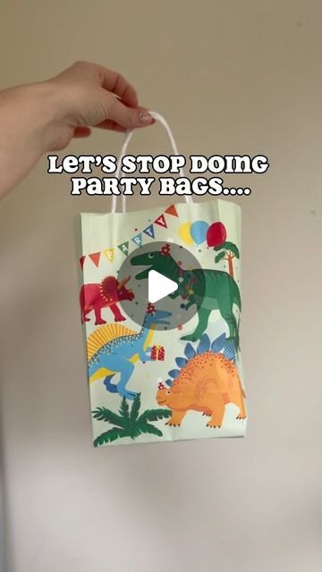 someone holding up a party bag with dinosaurs on it and the words let's stop doing party bags