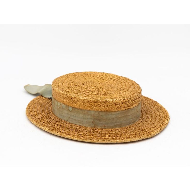 The Ridgemont Make's vintage 1930s boater hat showcases timeless elegance with its natural straw construction. Adorned with a pale blue ribbon and bow, this hat epitomizes classic style. The sturdy yet lightweight straw provides comfort and durability, while the charming ribbon adds a touch of sophistication. This boater hat captures the essence of vintage summer fashion, making it a coveted accessory for collectors and design enthusiasts alike. Seven are available for a display collection. Mode Vintage Adjustable Boater Hat With Flat Crown, Vintage Straw Boater Hat With Short Brim, Vintage Straw Panama Hat With Short Brim, Vintage Straw Panama Hat With Curved Brim, Vintage Straw Boater Hat With Flat Brim, Vintage Short Brim Straw Panama Hat, Vintage Natural Boater Hat With Short Brim, Vintage Straw Panama Hat For Kentucky Derby, Vintage Flat Crown Hats For Beach