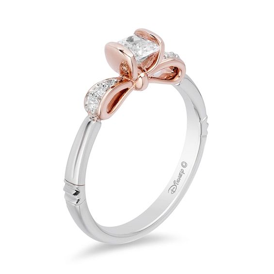 a white and rose gold ring with two diamonds on the top, one diamond in the middle