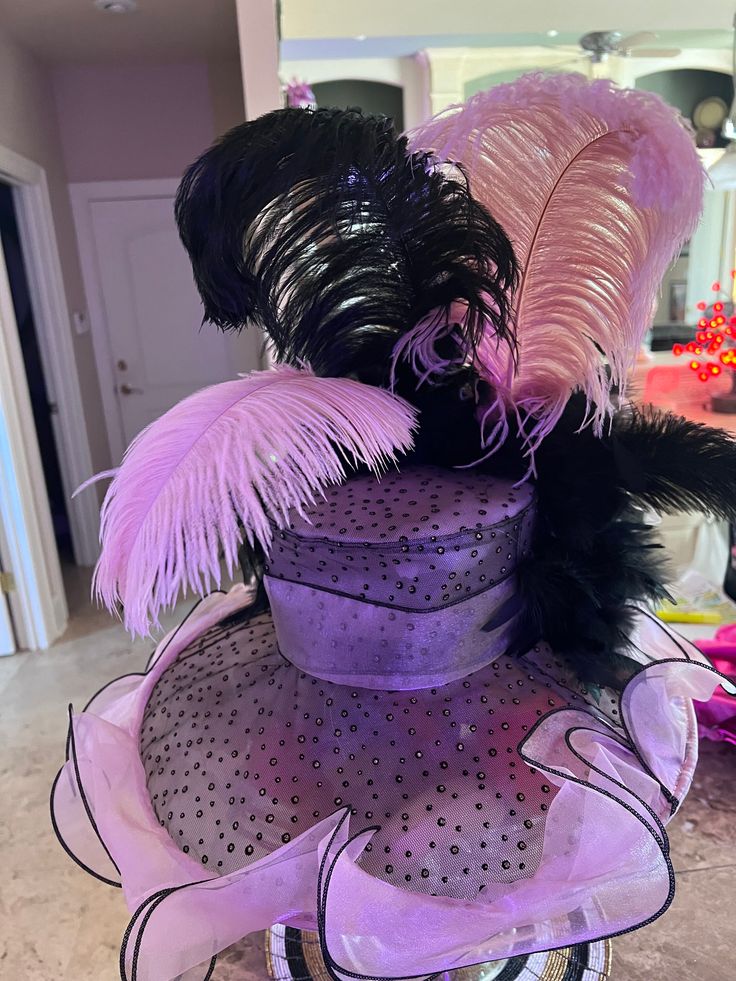 Pink and black trimmed ruffle derby style hat with sparkle polka dots . Handcrafted by designer with giant matching bow, black feather boa, black and pink feathers Feather Trim Mini Hats For Kentucky Derby Evening, Kentucky Derby Evening Mini Hat With Feather Trim, Kentucky Derby Black Feathered Costume Hats, Black Feather Trim Mini Hats For Kentucky Derby, Black Mini Hats With Feather Trim For Kentucky Derby, Black Feather Trim Hat For Kentucky Derby, Feather Trim Costume Hats For Kentucky Derby Races, Black Feathered Hats And Headpieces For Kentucky Derby, Black Mini Hat With Feather Trim For Royal Ascot