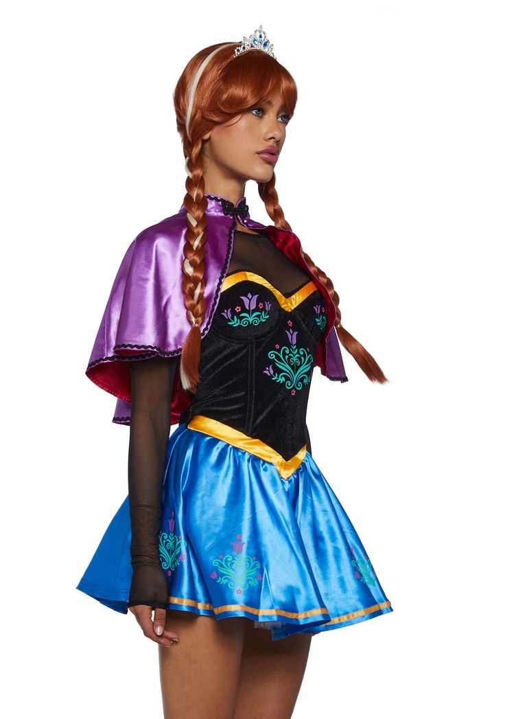 a woman in a costume with braids on her head and long hair wearing a blue skirt