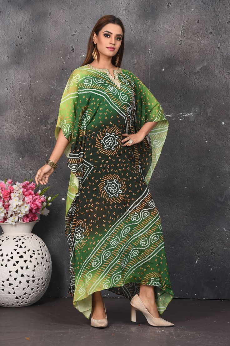 Elegant mehendi and parrot green bandhej kaftan dress is a perfect party and festive wear. Shop designer dresses in USA from Pure Elegance. Bollywood Style Green Dress For Eid, Green Bollywood Dress For Eid, Multicolor Bollywood Bandhani Print Dress, Bollywood Style Bandhani Print Multicolor Dress, Bollywood Style Multicolor Bandhani Dress, Bollywood Style Bandhani Print Dress, Eid Green Floor-length Maxi Dress, Green V-neck Kaftan For Eid, Green Floor-length Maxi Dress For Eid