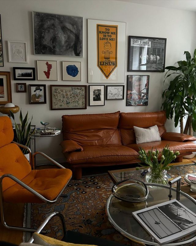 a living room filled with furniture and pictures on the wall