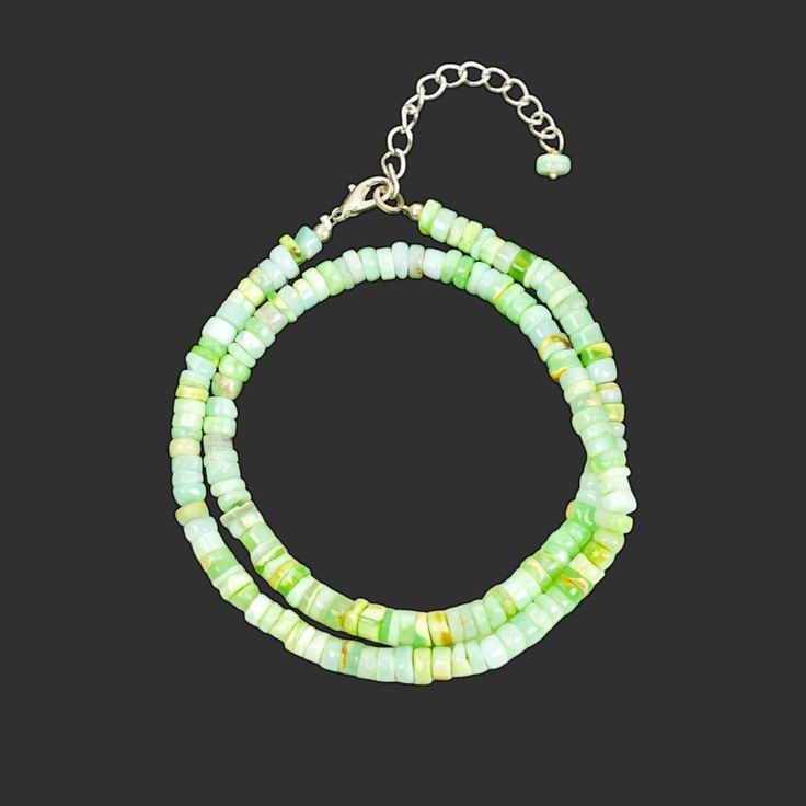 Shop all our Opal Necklaces here-  https://www.etsy.com/in-en/shop/GemsUniversaLindia?search_query=opal+necklace This listing is for Cute Green Opal Heishi Beads Necklace, Candy Opal Beaded Necklace, Opal Gemstone Tyre Beads Necklace, Candy Opal Jewelry, Handmade Choker. * Gemstone:  Opal  * Shape: Heishi * Style: Smooth Beads Necklace * Beads Size: 5-6mm * Clasp Material: Silver Plated  ADJUSTABLE LENGTH- There is a 2 inches long extender in the necklace. *Measurements are in round figure and a Heishi Beads Necklace, Opal Necklaces, Opal Choker, Handmade Chokers, Anniversary Necklace, Necklace Opal, Gemstone Beaded Necklace, Necklace Green, Green Opal