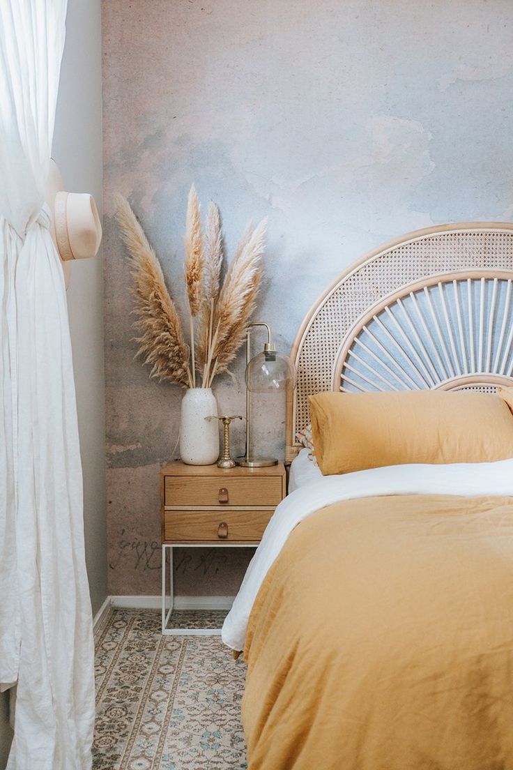 a bedroom with a wicker headboard and yellow bedding