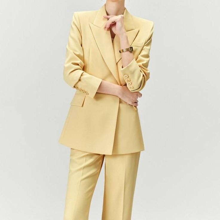 Discover Elegance and Professional Style Step into the office with confidence and style with our Elegant Yellow Pantsuit for Women. This chic and sophisticated two-piece set, featuring a long sleeve blazer and matching wide-leg pants, is the epitome of professional grace and modern fashion. Designed for the contemporary woman, this outfit seamlessly blends formal elegance with casual comfort, making it a versatile addition to your wardrobe. Exquisite Design and Quality Our pantsuit is crafted with meticulous attention to detail. The double-breasted blazer, with its sharp notched collar and full-length sleeves, pairs perfectly with the wide-leg pants, offering a slim and streamlined silhouette. The mid-waist design and flat front style ensure a flattering fit for all body types. The broadcl Chic Pantsuit With Lapel Collar For Office Wear, Tailored Spring Workwear Sets, Tailored Spring Sets For Workwear, Chic Spring Suits For Career, Spring Office Wear Pantsuit With Notch Lapel, Chic Career Pantsuit With Lapel Collar, Formal Long Sleeve Pantsuit For Fall, Chic Lapel Collar Pantsuit For Workwear, Chic Spring Career Suits