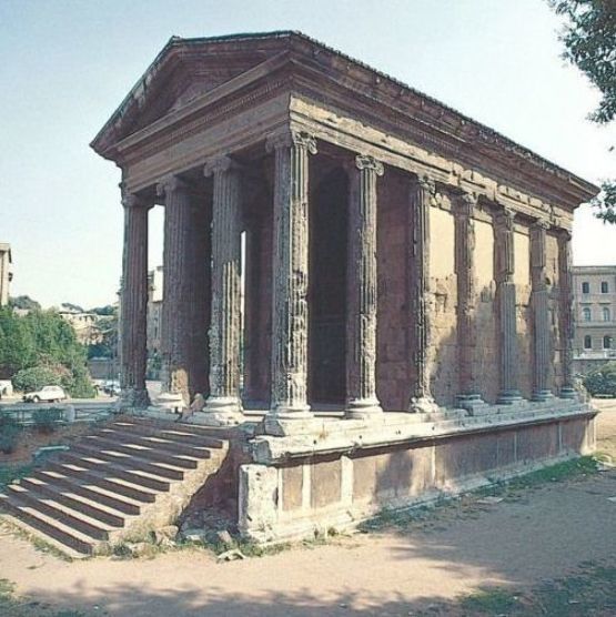 an old building with steps leading up to it and trees in the backgroud