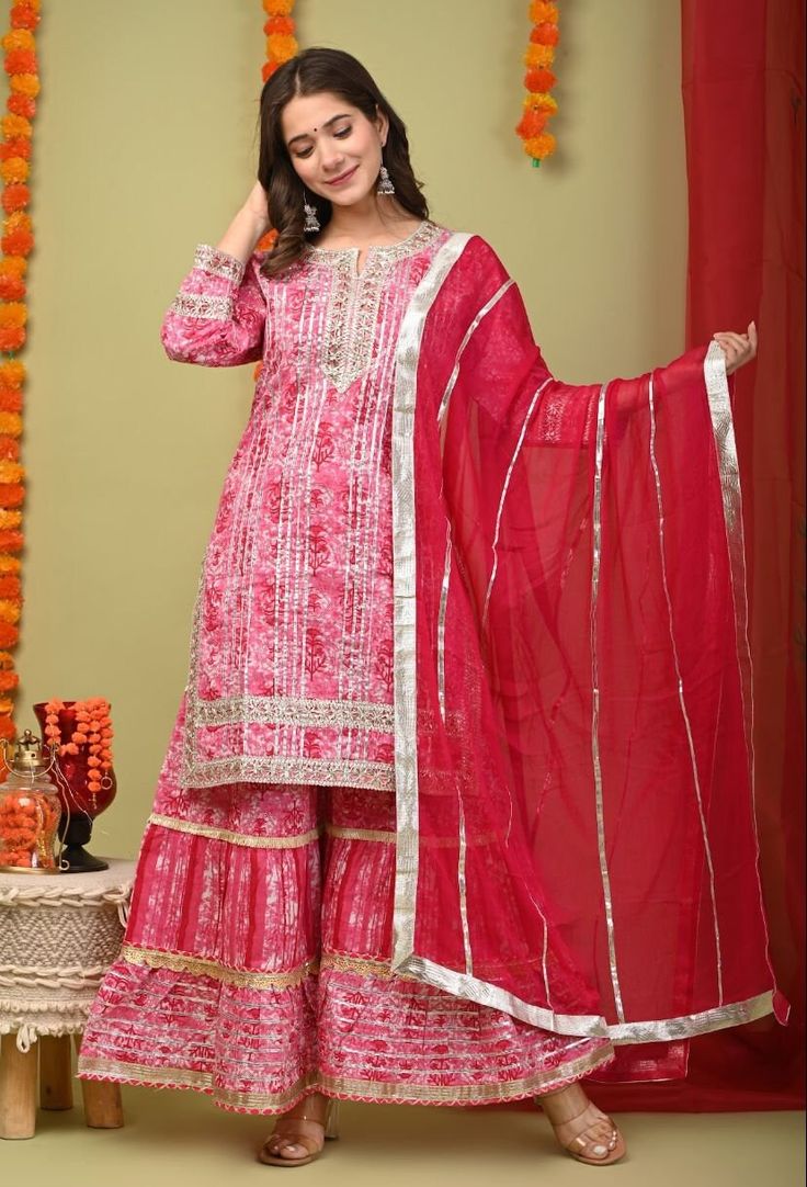 Elevate your ethnic wardrobe with our stunning Cotton Gota Work Sharara Kurta and Georgette Dupatta Suit Set. This exquisite ensemble combines traditional craftsmanship with modern elegance, making it perfect for any special occasion. Features: Material: Soft and breathable cotton for the kurta and sharara, with a lightweight georgette dupatta Design: Intricate gota work embellishments on the kurta and sharara Style: Flowy sharara pants paired with a beautifully crafted kurta and a matching geor Georgette Anarkali Set For Traditional Ceremonies During Diwali, Diwali Georgette Sets With Gota Work, Traditional Pink Sharara For Ceremonies, Pink Unstitched Sharara For Traditional Ceremonies, Chandbali Georgette Set For Diwali, Festive Palazzo Set With Dupatta For Traditional Ceremonies, Eid Sharara With Mirror Work For Traditional Ceremonies, Pink Semi-stitched Sharara For Traditional Ceremonies, Pink Anarkali Set For Diwali Ceremonies