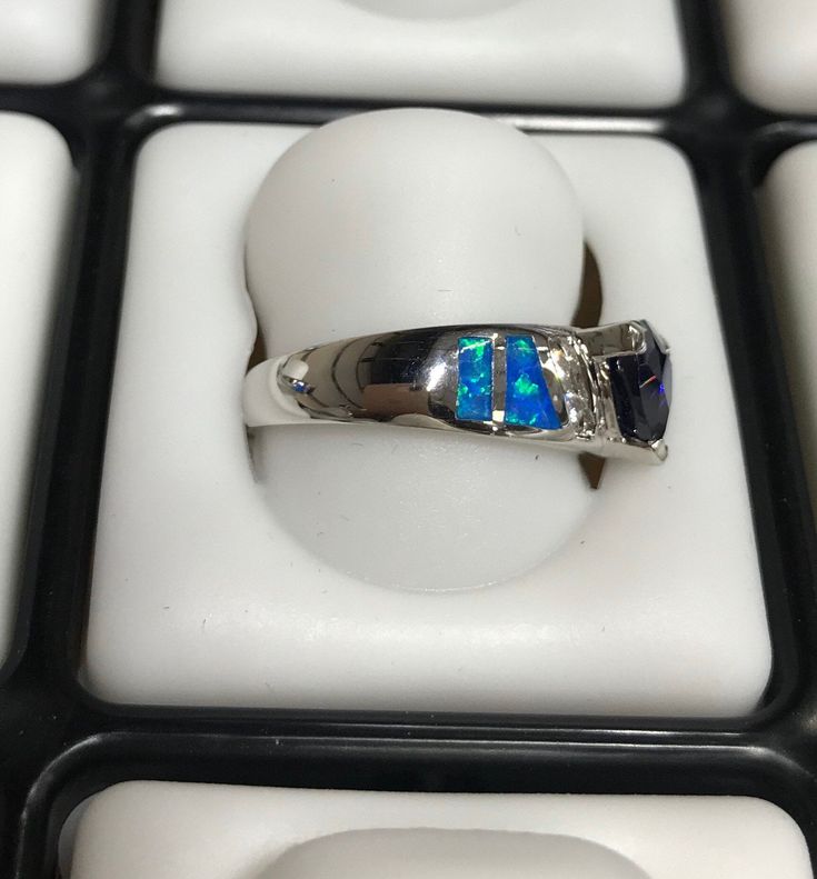 Fabulous brand new high quality silver ring with lab created blue inlay Fire Opals and 7mm Trillion cut Tanzanite, and White Topaz stones set on solid 925 sterling silver and stamped with 925. Our silver is genuine 925 sterling silver and Rhodium plated for better quality and prolonged shine. You will receive the item in a gift box Thanks for looking and check out more items in my Etsy shop for more great items and deals! https://www.etsy.com/shop/925usa Payment: We accept all major credit cards Blue Sterling Silver Jewelry With Channel Set, Blue Sterling Silver Jewelry Channel Set, Blue Sterling Silver Rings With Channel Set, Blue Trillion Cut Sterling Silver Ring, Sterling Silver Opal Ring With Accent Stones, Silver Multi-stone Opal Ring For Promise, Silver Trillion Cut Sapphire Ring With Accent Stones, Silver Opal Ring With Accent Stones, Round Cut, Gift Sapphire Ring Channel Set In Sterling Silver