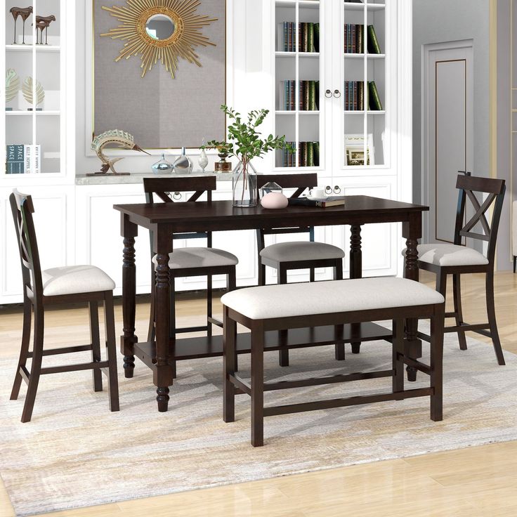 a dinning room table with four chairs and a bench