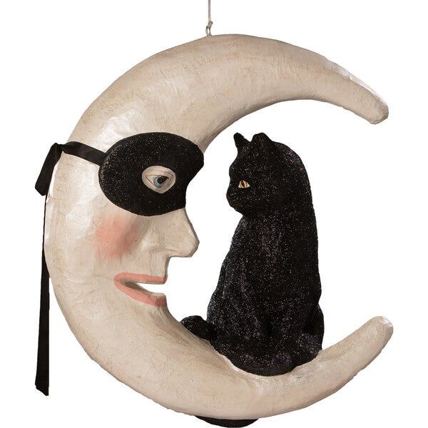 a black cat sitting on top of a crescent moon next to a man's face