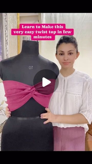 a woman standing next to a dress on a mannequin