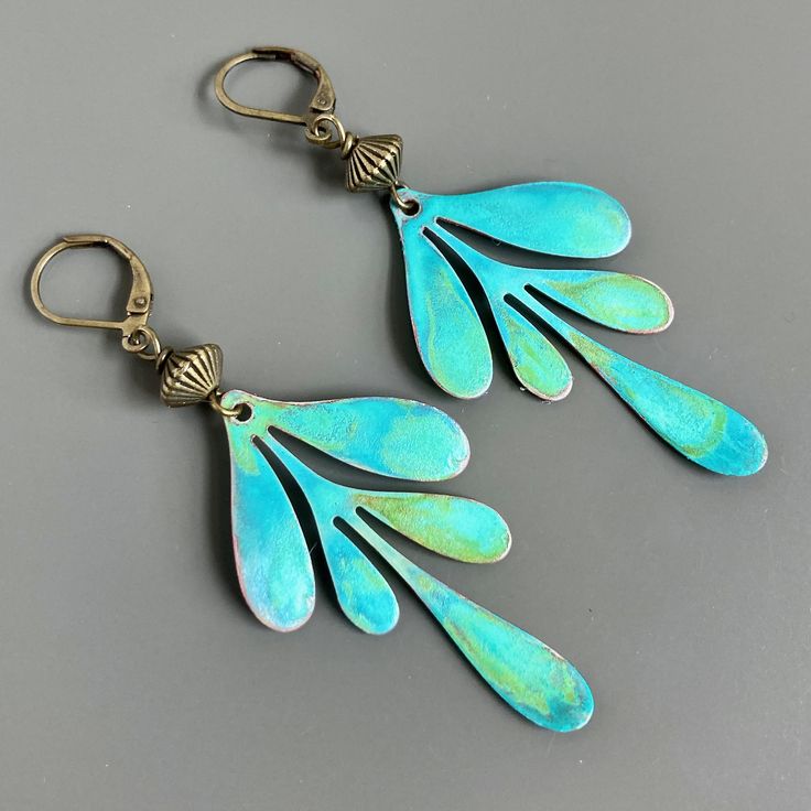 "Patina Leaf Earrings - Verdigris Patina Leaves dangle from Fluted Brass Bicone Beads.  These earrings are lightweight for comfortable wearing. Leaves are just under 2\" x 1\" This is a stock photo.  The patina will vary slightly. Brass Leverback Earwires Earrings measure 2.75\" from top of earwires to bottom." Whimsical Blue Nickel-free Earrings, Artistic Turquoise Earrings With Ear Wire, Whimsical Turquoise Nickel-free Earrings, Artsy Nickel-free Turquoise Earrings, Artsy Blue Teardrop Earrings, Artsy Turquoise Nickel-free Earrings, Artsy Turquoise Nickel-free Jewelry, Elegant Green Patina Earrings, Unique Turquoise Metal Earrings