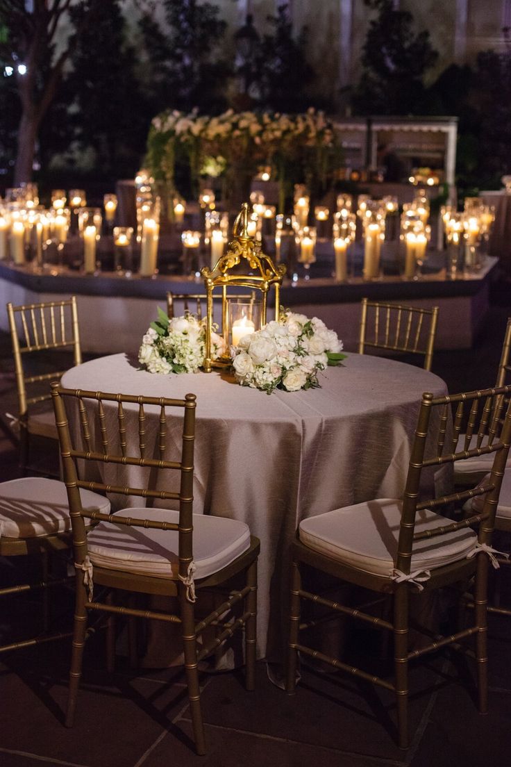 the table is set with candles and flowers for an elegant wedding reception at the four seasons hotel