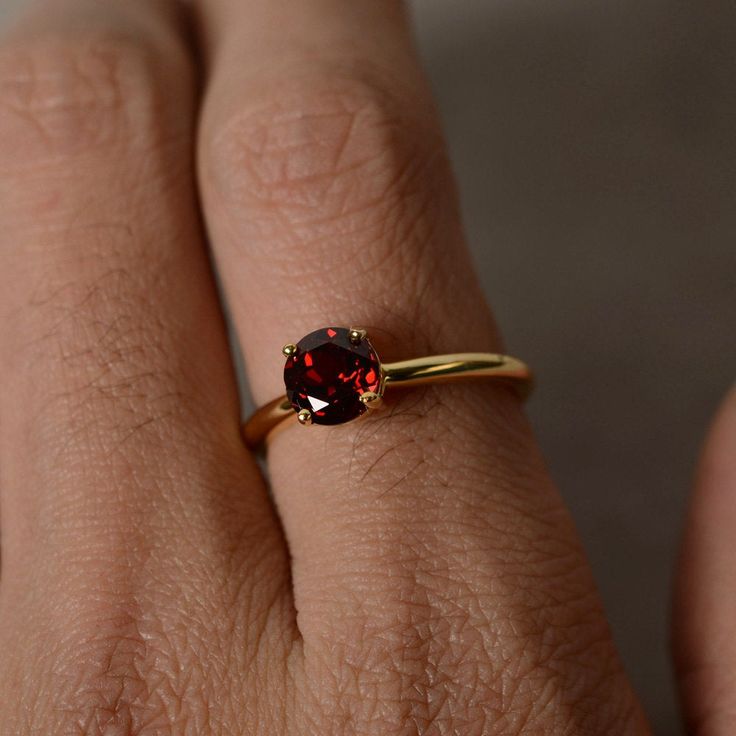 This is a gorgeous handmade creation. Its beauty is its simplicity & Elegance. The 7mm round cut garnet is crafted in solid sterling silver and with yellow gold plated. All item is sent in a beautiful gift box You can realize more lovely stuff clicking the link https://www.etsy.com/shop/knightjewelry?refshopsection_shophome_leftnav Please leave the correct address and you phone number for delivering successfully. Garnet Birthstone Ring For Anniversary, Anniversary Garnet Birthstone Ring, Birthstone Ring With Polished Finish For Gift, Polished Finish Birthstone Ring As Gift, Polished Finish Birthstone Ring With Round Stone, Gift Birthstone Ring With Polished Round Stone, Classic Yellow Gold Garnet Birthstone Ring, Classic Garnet Birthstone Ring In Yellow Gold, Timeless Birthstone Ring For Gifts