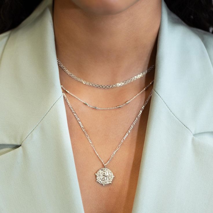 This necklace features a Sterling Silver coin pendant on a Figaro chain. Layer with necklaces from our Patented O collection. Pendant Diameter 0.6in (1.5cm) Figaro chain, 2mm Adjustable chain: 17-19in (44-48cm) When layered, chain length is: 17-21in (44-53cm) Learn more Sterling Silver Spring clasp closure Hypoallergenic, lead and nickel free #290S Layering Jewelry With Cable Chain, Medallion Coin Necklace With Cable Chain As Gift, Medallion Coin Necklace On Cable Chain As Gift, Chain Necklace With Coin Pendant For Layering, Elegant Coin Necklace With Adjustable Chain, Elegant Silver Coin Necklace With Adjustable Chain, White Gold Necklace With Figaro Chain Link, Silver Sterling Silver Coin Necklace With Delicate Chain, Elegant Coin-shaped Chain Necklace With Adjustable Chain