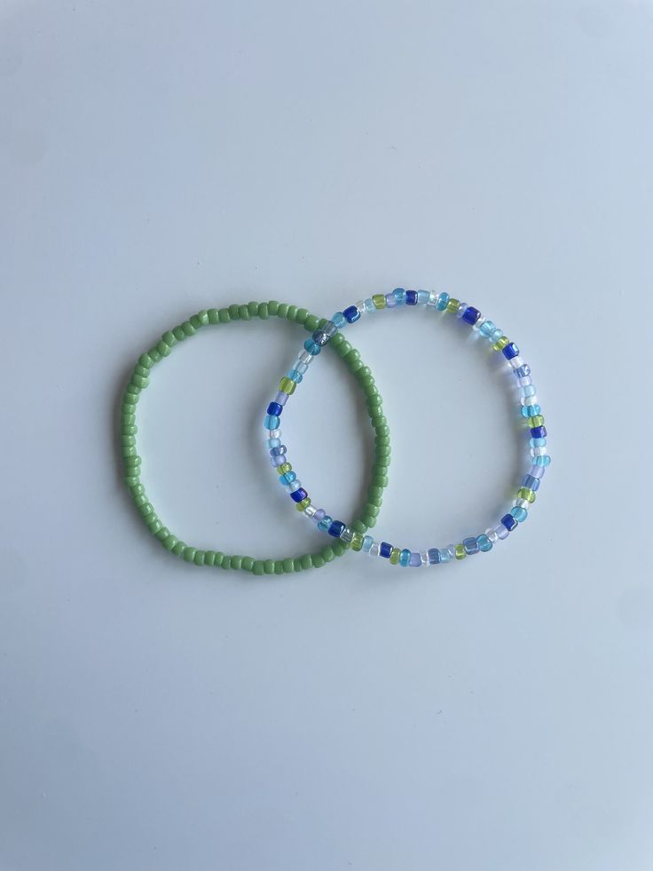 Stretchy bracelet set (2) - multi-blue green bracelet, light green bracelet These bracelets come in a set of two. They are meticulously handmade with seed beads and stretchy string. The durable bracelets are all triple knotted and glued shut. DISCLAIMER ON RETURN/EXCHANGE POLICY ~ Slightly mis-shaped bracelets due to knotting of the stretchy string is NOT INCLUDED in the return/exchange policy ~ Stretched out bracelets due to use over time is NOT INCLUDED in the return/exchange policy ~ Only broken beads or broken string within the return/exchange policy window ARE INCLUDED in the return/exchange policy Cheap Handmade Blue Beaded Bracelets, Small Bead Bracelet, Green Beaded Bracelets, Green Inspiration, Green Bracelet, Beads Bracelet Design, Stretchy Bracelets, Seed Bead Bracelets, Beading Tutorials