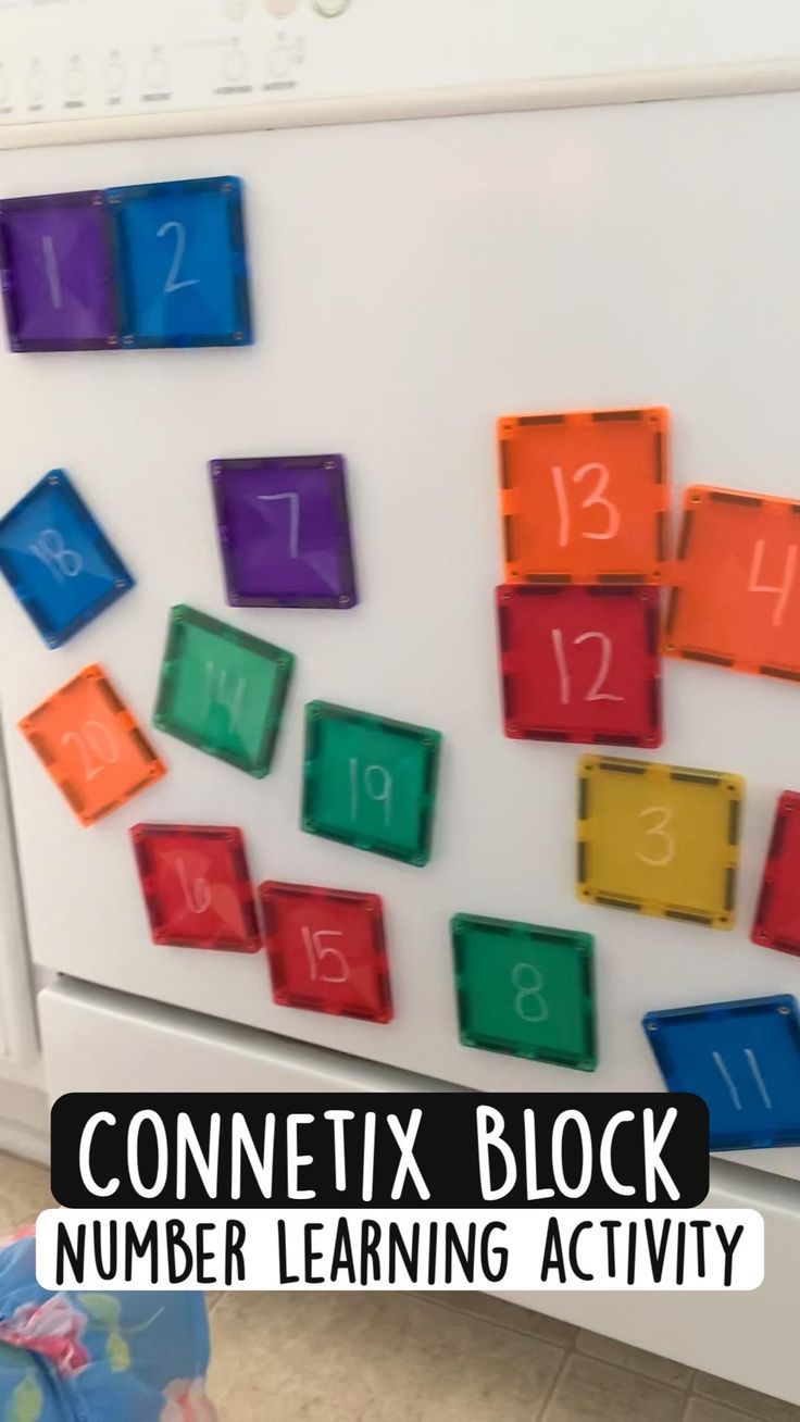 a white refrigerator with colorful magnets on it and the words connect block number learning activity