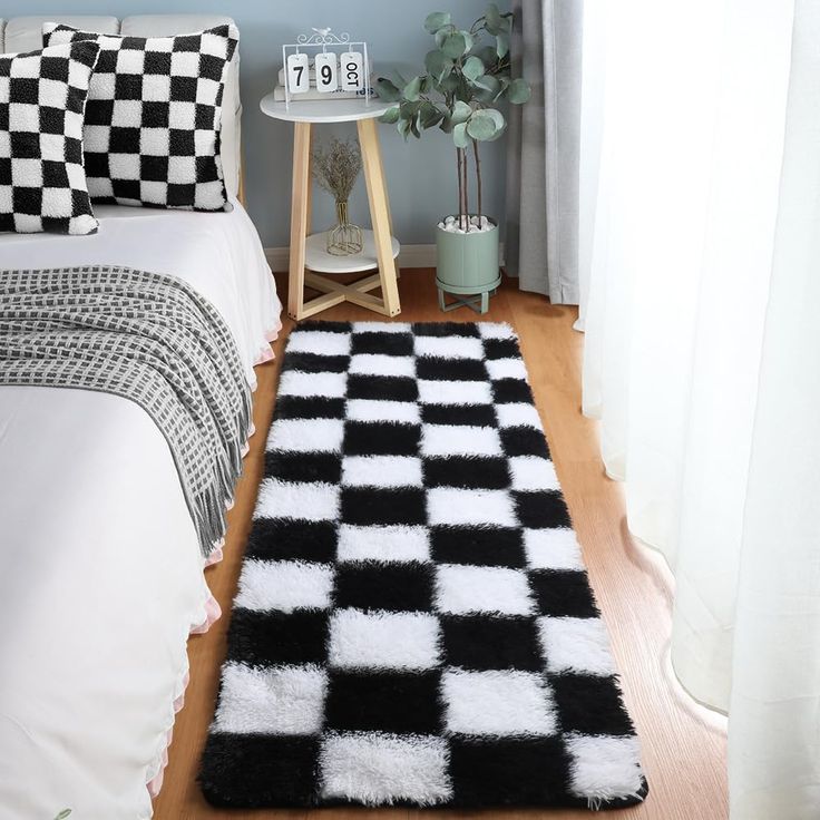 a black and white checkered rug in a bedroom