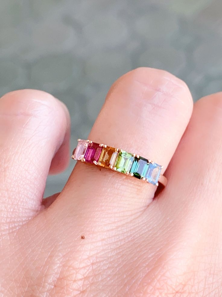 Add a splash of color and playful style to your everyday look with this 14K gold Rainbow Tourmaline Stacking Band. Perfect for layering, this unique and eye-catching band adds a vibrant touch to any outfit! Dare to make a fashion statement and become the envy of all your friends! ♥ The overall setting measures 17.8 mm in width, 4.3 mm in length, and sits 3.3 mm tall, band width is 1.7 mm♥ We have 3 rings in stock. What you see is what you will receive! ♥ Ring Size: US 7 (Free resizing up or down Rainbow Tourmaline, Rings Pink, Gemstone Wedding, Yellow Gifts, Playful Style, Stacking Bands, Montana Sapphire, Pink Ring, Stackable Rings