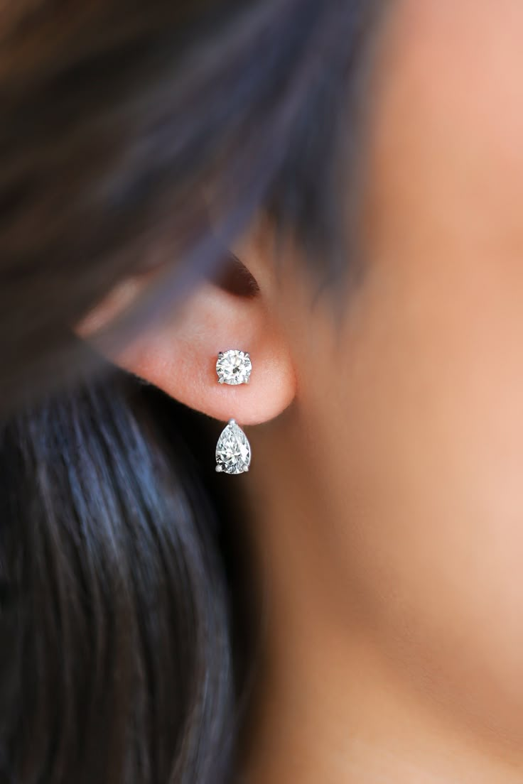 Oh, she so pretty! A subtle yet statement-making piece, the Solitaire Drop Ear Jacket transforms classic studs into unique, modern looks. Designed to invite light from all angles, this drop jacket adds an elevated touch of elegance to any existing Solitaire Stud--or pairs beautifully with any other stud earring for a versatile, chic effect. Details: Stone: Pear-Shaped Lab-Grown Diamonds Total Carat Weight: 1 TCW (0.5 CT Each) Diamond Quality: F Color, VS Clarity Design: Drop Ear Jacket (Compatib Single Diamond Drop Earring, Pear Shape Earrings Studs, Pear Earrings Studs, Unique Jewelry Earrings, Solitaire Drop Earrings, Solitaire Studs Earrings, Diamond Earing Designs Unique Modern, Diamond Studded Earrings, Lab Grown Diamond Earrings