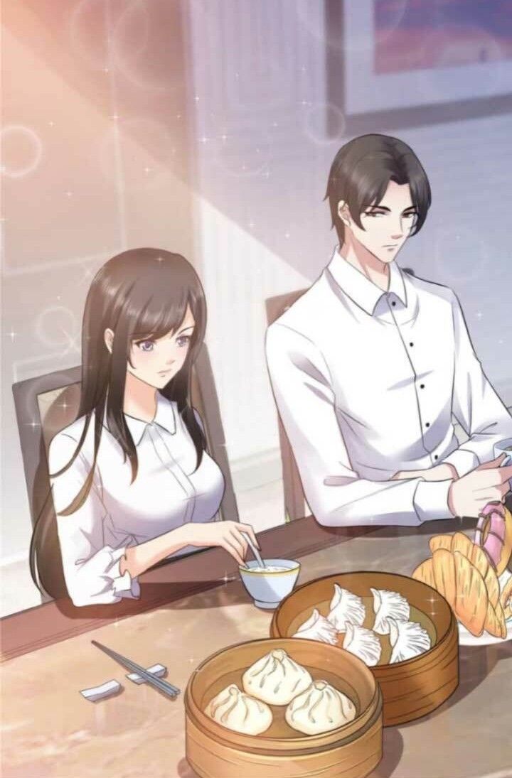 two people sitting at a table with food in front of them and one person holding a spoon