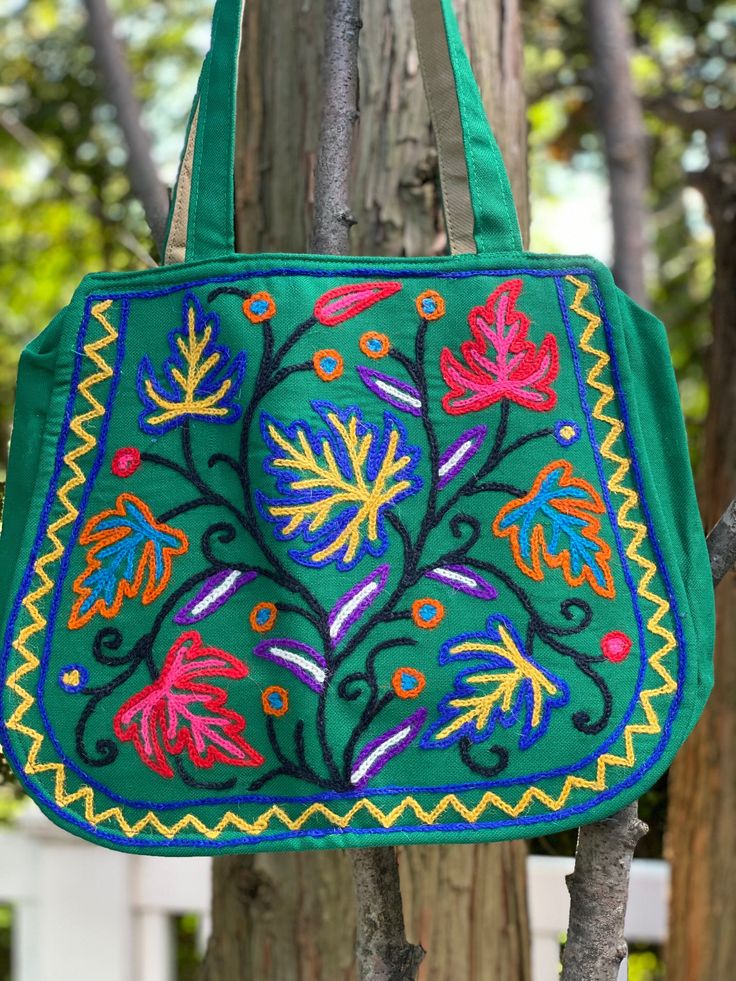 an embroidered bag hanging from a tree