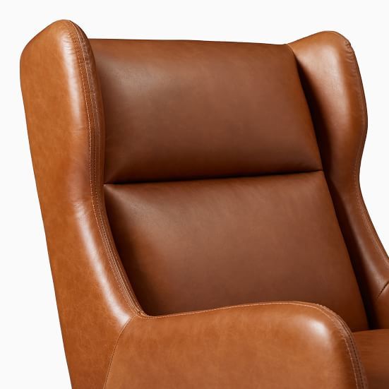 a brown leather reclining chair against a white background with the seat upholstered