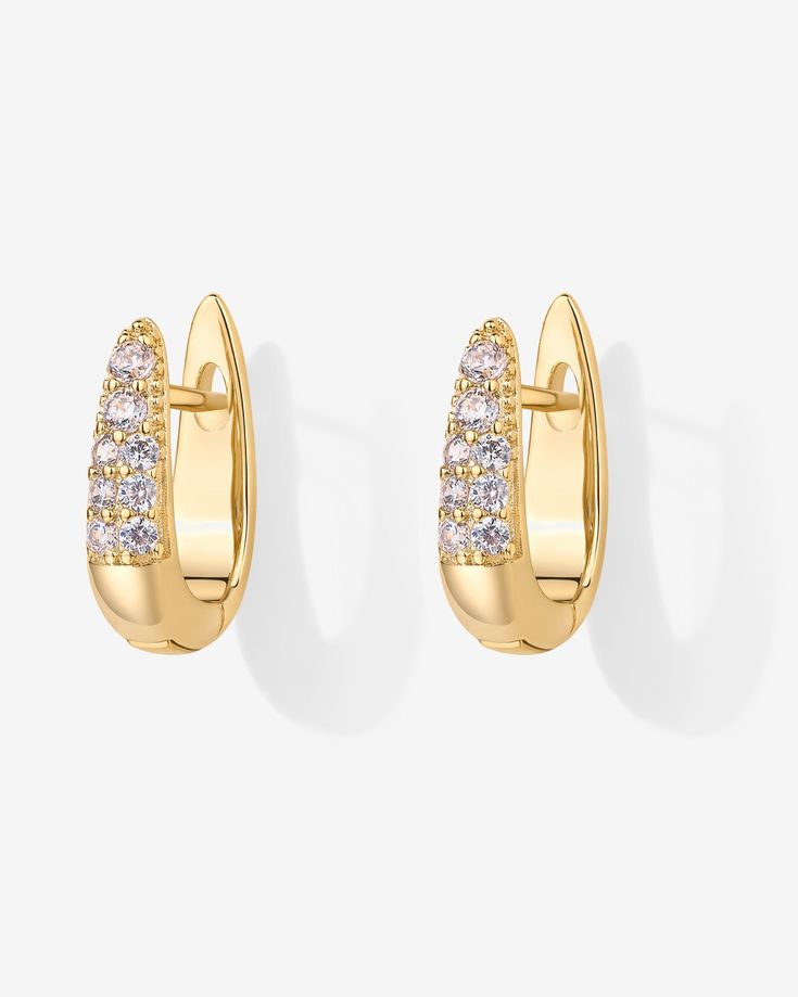 Elevate your style effortlessly with these chic earrings! Featuring stunning AAAAA cubic zirconia stones that catch the light just right, they add a touch of glam to any look, day or night. Materials: 925 sterling silver posts 18K Yellow Gold or Rhodium plated Measurements: Length: 16mm; Width: 4.5mm. Hypoallergenic, nickel free, and lead-free. Classic Huggie Earrings With Cubic Zirconia, Classic Cubic Zirconia Huggie Earrings For Pierced Ears, Modern Huggie Earrings In Diamond White Cubic Zirconia, Modern Diamond White Cubic Zirconia Huggie Earrings, Elegant Huggie Earrings For Party, Elegant White Gold Huggie Earrings With Sparkling Stones, Classic Huggie Cubic Zirconia Earrings, Diamond Huggie Earrings With Sparkling Stones For Gift, Elegant Huggie Earrings With Sparkling Stones For Gift