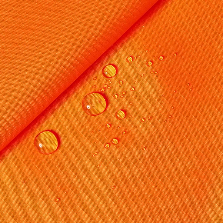 an orange fabric with water drops on it