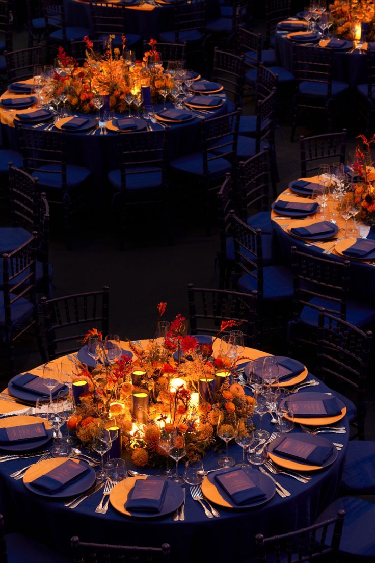 the tables are set up with candles and place settings for dinner guests to enjoy their meal