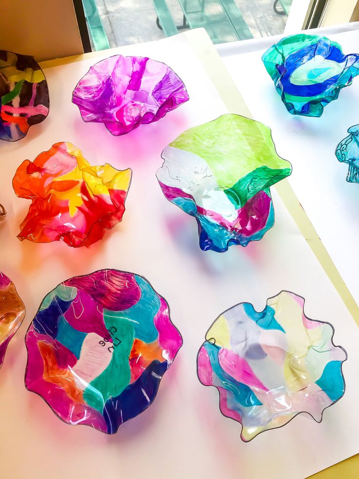 several colorful glass bowls sitting on top of a table