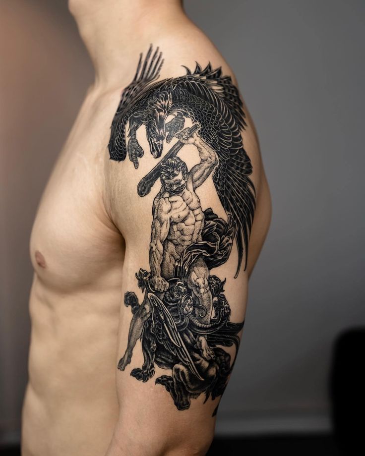 a man with a dragon tattoo on his arm and shoulder is standing in front of the camera