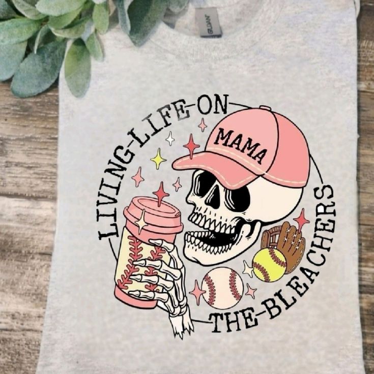 a t - shirt with a skull holding a baseball bat and ball on it that says tittle life on mama the bleachers