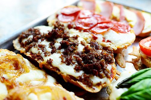 some food is laying out on a plate with lettuce, tomatoes and other toppings