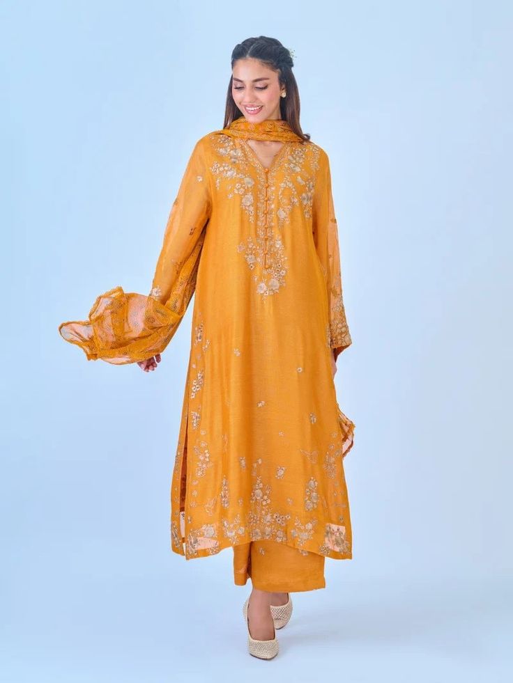 Elegant embroidered cotton net shirt with pants and dupatta a perfect choice for those who appreciate intricate detailing and graceful style. Crafted from high-quality cotton net fabric, this shirt offers a lightweight and luxurious feel, allowing you to feel comfortable and chic throughout the day. The set comes with a matching dupatta and pant which enhances the overall look and adds a touch of finesse to your outfit. Length: 47" Pants Fabric : Raw Silk Dupatta Fabric : Chiffon Long Sleeve Cotton Silk Kurta With Sheer Dupatta, Festive Kurta With Sheer Dupatta And Long Sleeves, Festival Kurta With Sheer Dupatta And Long Sleeves, Festival Long Sleeve Kurta With Sheer Dupatta, Traditional Wear Straight Kurta With Sheer Dupatta In Mulmul, Cotton Silk Traditional Wear With Dabka Work, Traditional Wear Straight Kurta With Sheer Dupatta, Cotton Silk Churidar With Sheer Dupatta, Chanderi Churidar With Zari Work And Long Sleeves