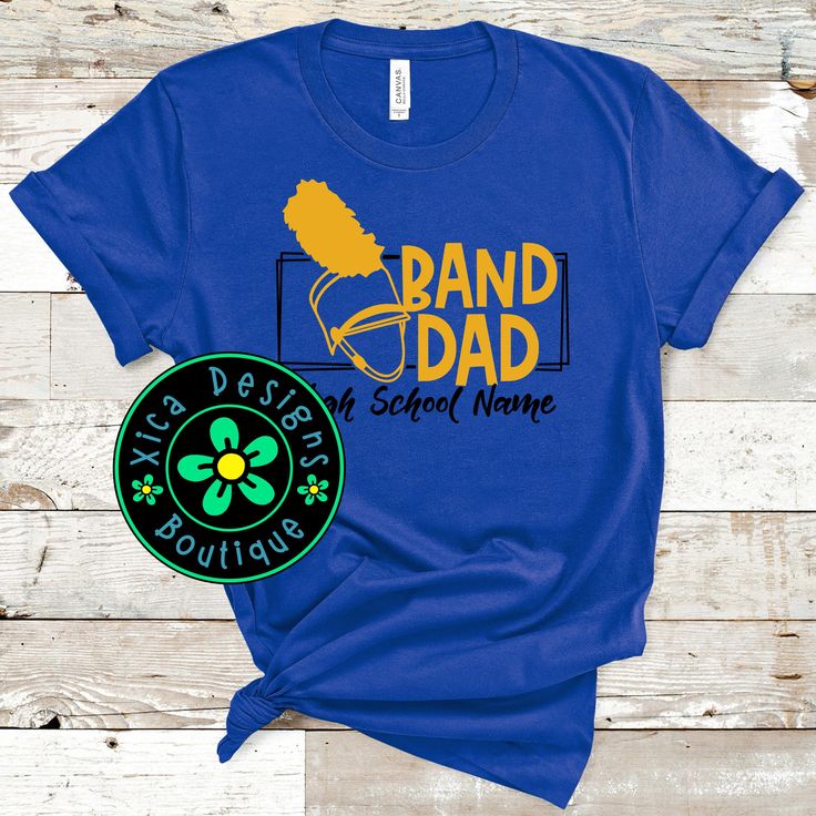 Band Dad Shirt, Shako Shirt, Band Dad Shako, High School Marching Band, College Marching Band Shirt, Percussion Shirt, Direct To Garment THIS SHIRT IS PRINTED DIRECTLY ONTO THE FABRIC WITH AN INDUSTRIAL-GRADE PRINTER, USING HIGH-QUALITY INK, WHICH PROVIDES LONG-LASTING AND THE BEST IMAGE ADHESION POSSIBLE ON T-SHIRTS AND GARMENTS.  BEFORE HITTING THE MARKETS OUR CUSTOM DTG TECHNOLOGY SUCCESSFULLY PASSED RIGOROUS TESTING THAT INCLUDED MORE THAN 30 MACHINE WASHING AND DRYING WITHOUT FADING OR CRAC Father's Day School Spirit Cotton T-shirt, Band Merch Cotton Tops For School, Cotton Band Merch Tops For School, School Cotton Tops With Band Merch Style, School Tops In Cotton With Band Merch Style, Cotton Shirt With Name Print For Fans, Father's Day Pre-shrunk Blue Shirt, Band Merch T-shirt With Name Print In Cotton, Blue Cotton Shirt With Name Print