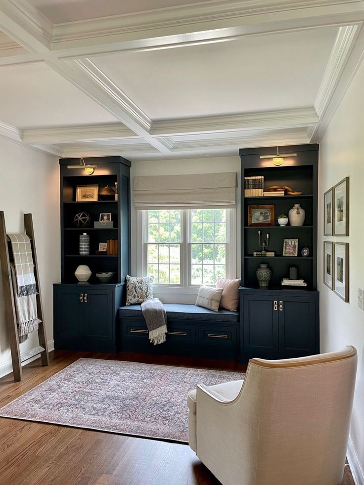 a living room with built in bookshelves and a couch next to a window