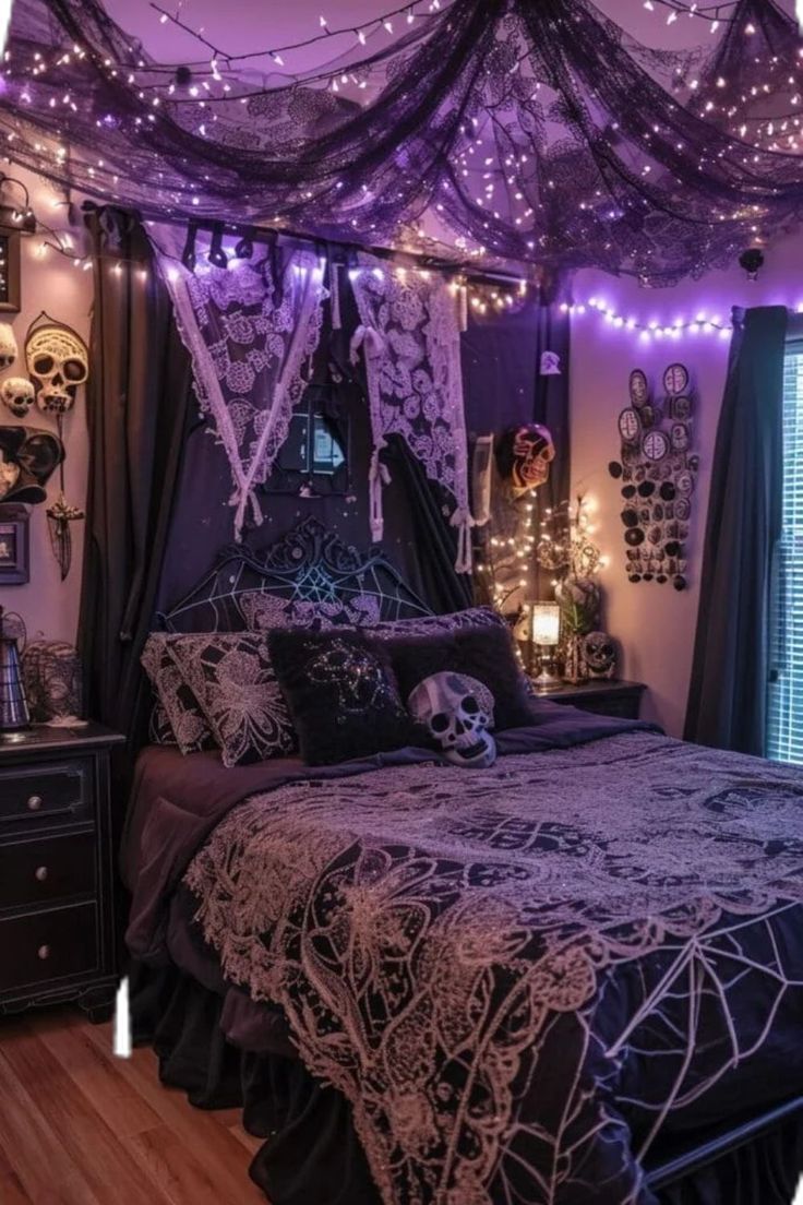 a bedroom decorated in purple and black with string lights