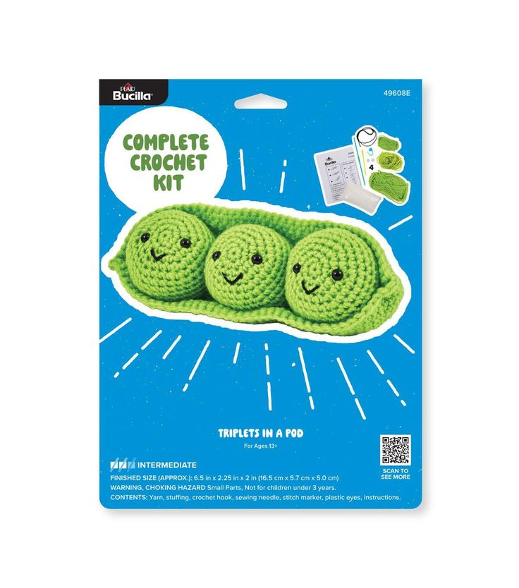 the crochet kit includes three peas with smiling faces on them, and an envelope for