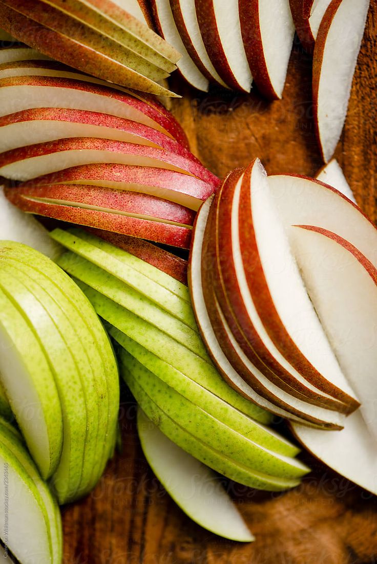 sliced apples are arranged on a cutting board