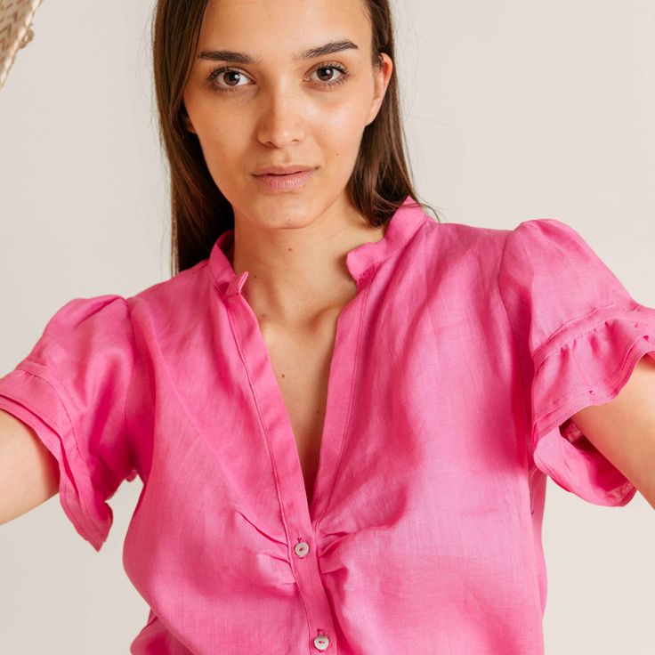 PRODUCT DETAILS Olivia Linen Top - romantic, light, airy, and available in vibrant spring/summer colors. Perfect for any summer look, this shirt combines effortless style with the breezy comfort of linen. Elevate your wardrobe with Olivia's pop of color. Designed in New York City. Sustainably made in Bosnia & Herzegovina. FIT & SIZING The delicate ruffle sleeve detailing adds a touch of charm. Model is 179cm / 5’ 101/2’’ and wears size S/M. FABRIC & CARE 100% high-quality linen 30°C machine wash Feminine Linen V-neck Blouse, Feminine Pink Shirt For Summer, Feminine Pink Summer Shirt, Feminine Pink Linen Top, Casual Linen Spring Blouse, Summer Linen Shirt For Day Out, Spring Chic Linen Blouse, Chic Linen Spring Blouse, Breezy Linen Tops For Summer