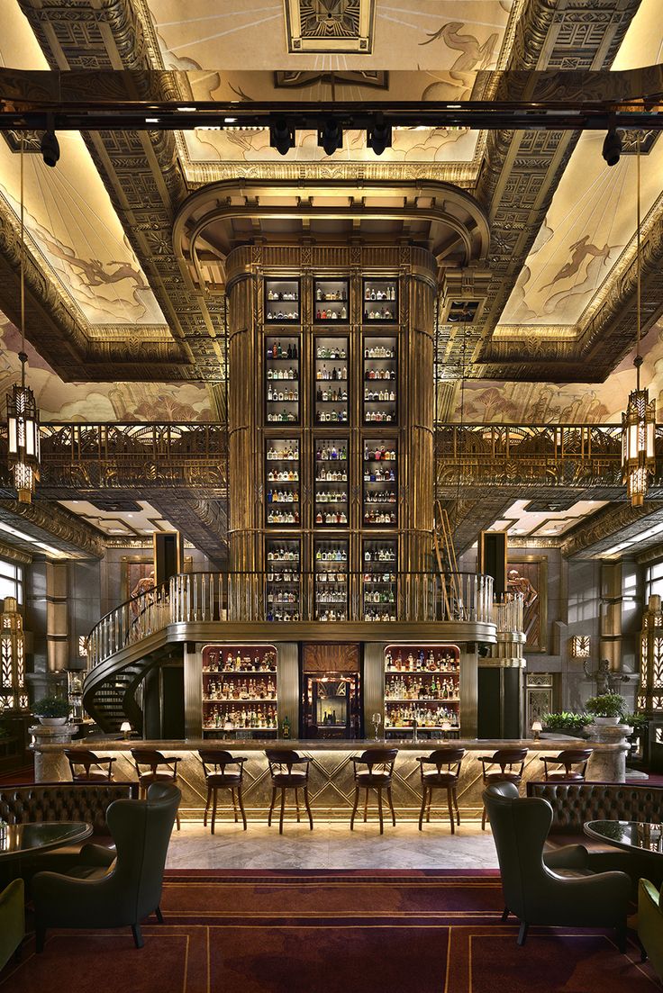 the interior of a restaurant with many tables and chairs, along with lots of bookshelves