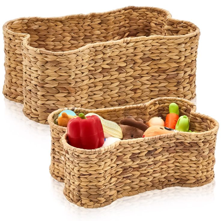 two wicker baskets filled with different types of food and candy, on a white background