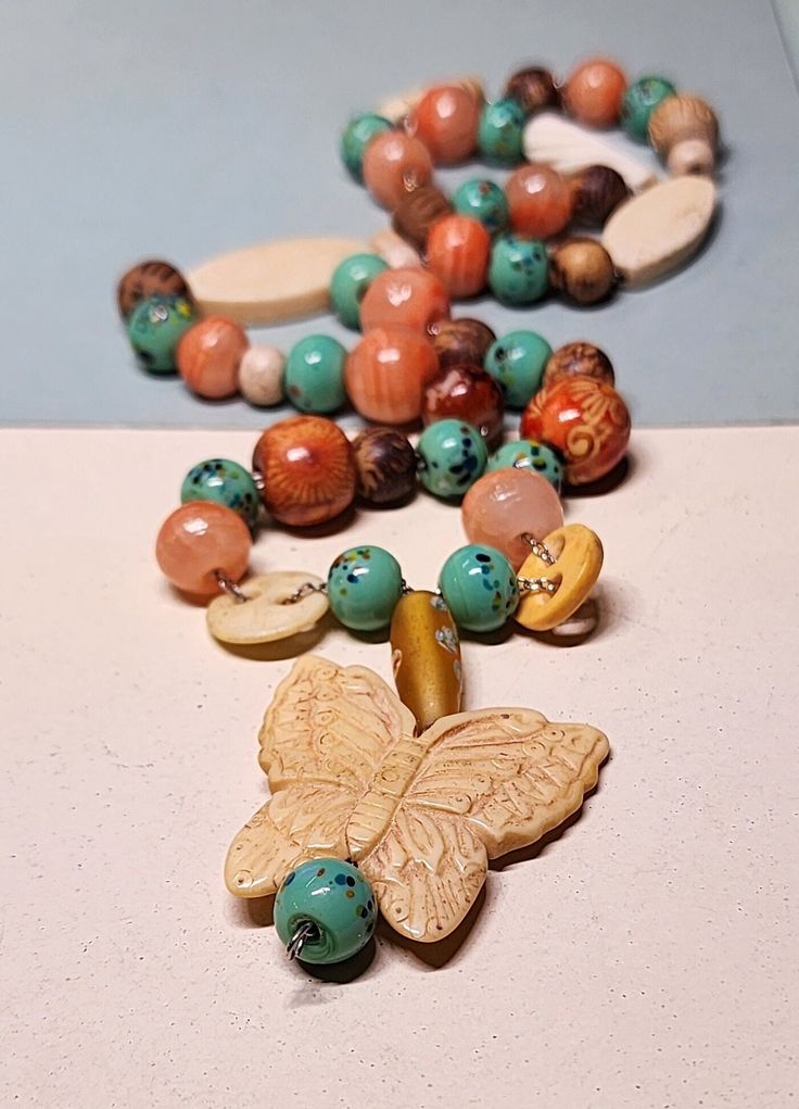 This is a for a vintage carved resin butterfly stone and glass beaded necklace. The chain is not the original one. This is in good condition, and is unsigned with no markings. It has not been cleaned and has usual wear and tear for the age. The photos don't always depict the true color. I took several pictures so you could see clearly the condition they are in. This is a used item and sold as is. If you have any problems with an item please message me. I will do my best to work with customers about any issues you may have. I sell an item as is, so items are many times imperfect. This item has free shipping. Resin Butterfly, Beaded Butterfly, Butterfly Necklace, Glass Bead Necklace, Necklace Vintage, Glass Necklace, Jewelry Vintage, Flea Market, Vintage Necklace