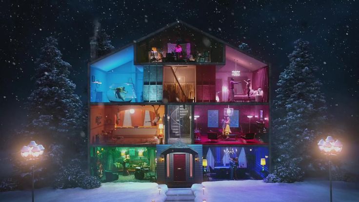 an animated house is lit up in the snow at night with lights shining on it